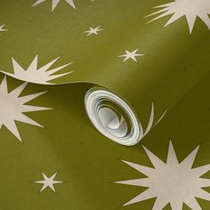 a green and white wallpaper with stars on it