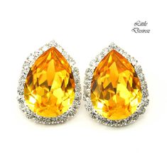 These timeless Swarovski Yellow Earrings have a Victorian touch of elegance and romance! A bright, happy and super sparkly jewelry that will light up your day!  The earrings feature 18x13mm Swarovski bright Sunflower Yellow teardrop stone at the center, surrounded with smaller Swarovski clear rhinestones. The Swarovski crystals are prong set in Sterling Silver plated brass setting.  Lightweight and comfortable to wear! Perfect for brides, bridesmaids, special occasions or just any other day!  *A Bridesmaid Stud Earrings, Sunflower Earring, Fancy Stones, Sunflower Yellow, Sunflower Earrings, Sparkly Jewelry, Earrings Bridesmaid, Yellow Earrings, Wedding Jewelry Earrings