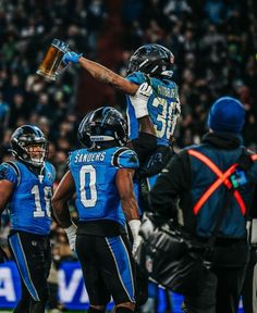 the football players are celebrating their team's victory over each other in a game