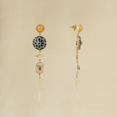 India-inspired, the Firdos earrings are a nod to 1940s Hollywood style, when chandelier earrings were a 'big thing'. These earrings bring together, in harmony, handcrafted units, each unique in themselves. Highlights of the story being an intricately enamelled - diamond studded disc and an ornate pearl strung oval-shaped disc. They are all held together by a bright yellow stud and a push-back closure. Gold(14K) : 9.51gRose-cut Diamonds : 0.95ctGemstone : Emerald, Ruby, Yellow Onyx, Cultured Pear Luxury Multi-stone 14k Gold Earrings, Fusion Style Jeweled Dangle Jewelry, Fusion Jeweled Dangle Jewelry, Fusion Style Jeweled Dangle Earrings, Fusion Jeweled Dangle Earrings, Fine Jewelry Round Chandelier Earrings For Pierced Ears, Fine Jewelry Round Chandelier Earrings, Round Chandelier Earrings In Fine Jewelry Style, Round Chandelier Earrings Fine Jewelry