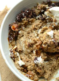 a bowl filled with oatmeal and raisins on top of a table