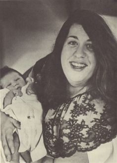 a woman holding a baby in her arms