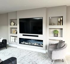 a living room with two couches and a flat screen tv mounted on the wall