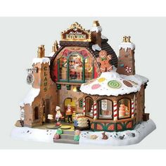 a gingerbread house is shown in the snow