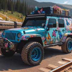 a blue jeep with butterflies painted on it