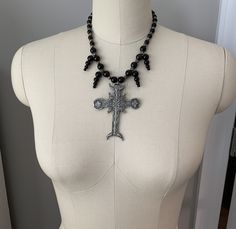 This beautiful, one-of-a-kind pewter ornate cross necklace will inspire all your moonlit nights. Handmade with black agate and glass beads. Measures 18 inches long and has a 2 inch extender chain. product details silver tone metals; Cross is soft pewter. 18 inches long with 2 inch extender black agate and glass beads VISIT MY SHOPS HERE * http://www.etsy.com/shop/HappyCatHouse * http://www.Etsy.com/shop/AnEnchantingCreature CONNECT * http://www.facebook.com/EnchantingCreature * https://www.insta Gothic Black Crucifix Cross Necklace, Gothic Metal Cross Necklaces, Gothic Black Cross Pendant Necklace, Gothic Metal Cross Necklace, Gothic Cross Necklaces For Jewelry Making, Ankh Shaped Black Metal Necklace, Black Ankh Necklace In Metal, Black Cross Pendant Jewelry For Halloween, Silver Ankh Gothic Necklace