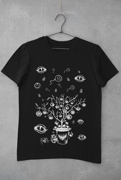 Thanks for stopping by! Eyeballs T-shirt Printed on a super soft, cotton tee Dispatched in 5 working days or sooner Unisex Free UK delivery Material: 100% ringspun cotton. Chest (to fit): S  34/36   M  38   L  40/42   XL  44/46   XXL  48/50 ECO-FRIENDLY Each garment is made to order, reducing extra material and energy that would be otherwise wasted We use DTG printing process which is easier on the environment than screen-printing Our ink is bright and also eco-friendly. Do not tumble dry. Wash Halloween Fairy Grunge Tops, Fairy Grunge Halloween T-shirt With Crew Neck, Halloween Fairy Grunge T-shirt With Crew Neck, Halloween Goblincore T-shirt With Graphic Print, Halloween Goblincore Graphic T-shirt, Black Fairy Grunge Cotton T-shirt, Goblincore Halloween Short Sleeve T-shirt, Black Goblincore Top With Graphic Print, Goblincore Halloween T-shirt With Short Sleeves