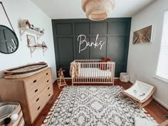 a baby's room with a crib, dresser and rug in the corner