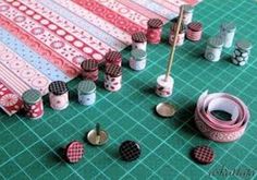 sewing supplies are laid out on a green cutting board with pins and threads in them