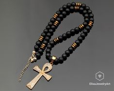 "Zirconia Ankh Cross Pendant Black Lava Hematite Beaded Birthstone Emotional Genuine Calming Necklace For Him Unisex Christmas Gift -ALL THE PRODUCTS AT ELISAJEWELRYART ARE HANDMADE AND MADE WITH NATURAL BEADS. -WHAT DOES THE LAVA STAND FOR Lava Stone is a grounding stone that strengthens one's connection to Mother Earth. It gives us strength and courage, allowing us stability through times of change. It provides guidance and understanding in situations where we may need to \"bounce back\". A ca Black Ankh Jewelry For Gifts, 8mm Bead Pendant Jewelry As Gift, Black Beaded Stone Necklaces For Gifts, Black Beaded Necklaces With Stones As Gift, Black Beaded Necklace With Stones, Spiritual Gemstone Beads Jewelry For Party, Gold Crystal Necklace With Black Beads As Gift, Gold Crystal Necklace With Black Beads For Gift, Gold Jewelry With Black Beads As A Gift