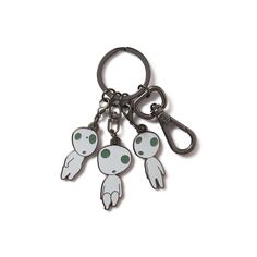 three ghost keychains with green eyes and hands hanging from each one's sides