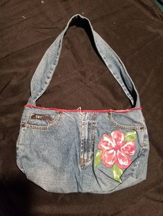 Blue jean purse is one of a kind. Made from upcycled Lei jeans with flower design. Pockets on the back and a 28 inch sturdy strap made from the jean legs. Velcro closures Size: 14 inches wide by 8 inches deep. Machine was delicate with cold water and air dry. Blue Jean Purses, Lei Jeans, Jean Purses, Denim Shoulder Bag, Shoulder Bag Pink, Jean Purse, Denim Purse, Denim Shoulder Bags, Quirky Fashion