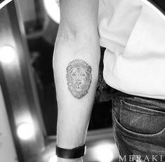 a man with a lion tattoo on his arm