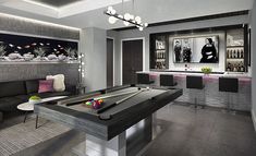 a living room filled with furniture and a pool table in front of a tv mounted on the wall