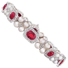 a red and white bracelet with pearls, diamonds and garnets on the clasp