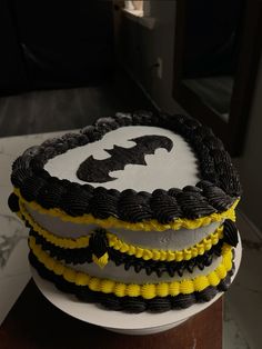 a batman themed cake with yellow and black icing