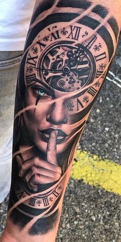 a man with a clock tattoo on his arm holding a finger up to his mouth