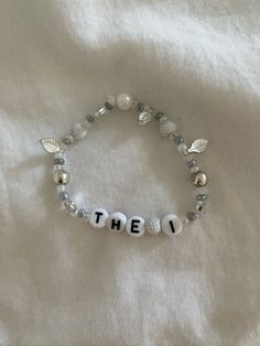 a beaded bracelet with the word'the i'written on it