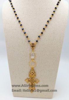 Brass Gold Coptic Cross Necklace, Long Black Rosary Chain Fashion Necklace, Ethiopian Cross Necklace, Beaded Rosary Chain Necklaces By Regina Harp Designs. D E T A I L S: Cross necklace in Picture #1 MA T E R I A L S: * Black Mystic AB Crystal Rosary in 22 k Gold plated wire wrapped 6 mm rondelle glass crystal beads. * Highest quality Gold Filled jump rings. Includes clear connector in rectangle shape. * 16 k Brushed Gold plated ring and Our Most Sacred Heart in Gold Pewter Center. L E N G T H: Spiritual Cross Necklace With Beaded Chain, Gold Metal Beaded Necklaces With Black Beads, Gold Metal Beaded Necklace With Black Beads, Gold Metal Necklace With Black Beads, Adjustable Cross Necklace With Black Beads, Adjustable Black Beads Cross Necklace, Cross Shaped Beaded Chain For Jewelry Making, Cross-shaped Beaded Chain For Jewelry Making, Cross-shaped Faceted Beads For Jewelry Making