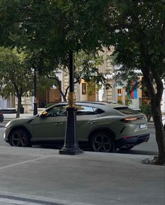 a car is parked on the street next to a lamp post