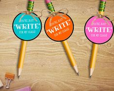 three colorful pencils with writing on them