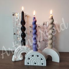 three candles sitting next to each other on a table