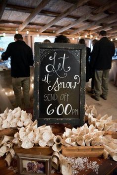 there is a sign that says let it snow send off 6 00 pm on the table