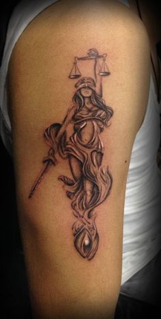 a lady justice tattoo on the arm