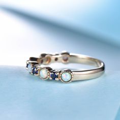 You are looking at a white fire Opal and sapphire wedding band. Stackable wedding band,matching band.A perfect anniversary gift, birthday gift,wedding engagement ring.Great as a gift for her. Ring Information Stones * 2.5mm Lab-treated opal +2mm lab created sapphire Metal * Solid 10k 14k &18k. *Color:white gold,yellow gold,rose gold. Custom Order *The main stone can be other gemstones you can imagine,any birthstone can be made.Please contact me if you need this service. *Any size *I can also Sapphire Stackable 14k Gold Rings For Wedding, Sapphire Stackable Rings In 14k Gold For Wedding, Sapphire Stackable Birthstone Ring For Wedding, Sapphire Stackable Wedding Rings In 14k Gold, Stackable 14k Gold Rings For Wedding, Stackable Sapphire Birthstone Ring For Wedding, Multi-stone Sapphire Birthstone Ring For Wedding, Sapphire Half Eternity Wedding Ring, Multi-stone Stackable Wedding Rings