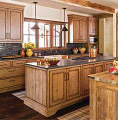 a kitchen filled with lots of wooden cabinets and counter top space next to a window