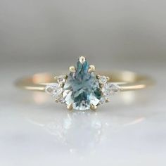 We love this timeless light blue sapphire ring with diamond accents in a yellow gold setting made by Gem Breakfast Montana Sapphire Engagement Ring, Stackable Engagement Ring, Gemstone Engagement, Montana Sapphire