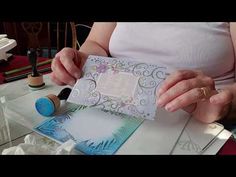 an older woman is working on some cards