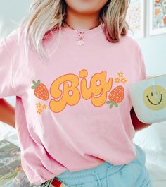 ✨ THE BIG LITTLE RETRO STRAWBERRY SHIRT - (BIG SIS) - COMFORT COLORS We cannot wait for you to get your hands on this strawberry inspired, big little reveal shirt! We have combined the retro vibe with the sorority style and we hope we did it justice and you love it! 😍 This is a perfect gift for any big/little sisters.  If you would like to discuss any alternative size, color or product options, please do not hesitate to contact us directly. 💌 ALSO AVAILABLE AS A 'LIL' TSHIRT: ➡️ ➡️ ➡️ https://www.etsy.com/listing/1570507400/lil-sorority-design-cc-shirt ✨ ABOUT OUR COMFORT COLORS TEES ✨ These 100% ring-spun cotton unisex tees are a great staple for any wardrobe and available in various different colours. The soft-washed, garment-dyed fabric brings extra coziness to your wardrobe while the Cute Pink T-shirt With Custom Print, Cute Pink Shirt With Custom Print, Pink Short Sleeve Sorority Tops, Cotton Sorority Top With Text Print, Sorority Letter Print Short Sleeve Tops, Sorority Short Sleeve Tops With Letter Print, Pink School Spirit Cotton Shirt, Sorority Graphic Print Summer Tops, Pink Short Sleeve Sorority T-shirt