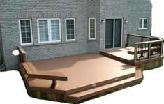 a large wooden deck in front of a house