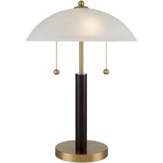 a lamp that is sitting on top of a metal stand with a white shade over it