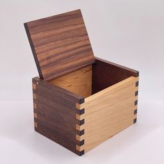 a wooden box with two compartments on the inside