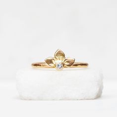 Diamond Snowdrop ring in 14k gold. Three handmade petals surround a sparkly white diamond. Comes on a 14k gold band with a hammered texture. Details : Diamond - 2.5mm Band - 1.6mm, hammered texture Finish - Choose between brushed satin and a shiny high polish at checkout. Pictured with the brushed satin finish. It's important to note that the photos are enlarged to show detail which can make the jewelry appear much larger than it is. Please look up the measurements I have noted on a ruler before 14k Gold Wedding Flower Ring With Diamond Accents, Gold Flower Ring With Single Diamond For Wedding, Yellow Gold Flower Ring With Single Diamond For Wedding, Gold Wedding Flower Ring With Single Diamond, Wedding Flower Ring With Single Diamond, Wedding Yellow Gold Flower Ring With Diamond, Yellow Gold Flower Ring With Single Diamond For Promise, Lotus Wedding Ring, Flower Ring Diamond