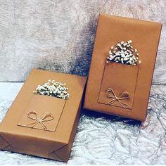 two brown boxes with small flowers in them