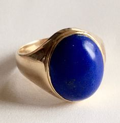 this is fantastic Mans vintage ring!! set with Lapis lazuli large cabochon All set in yellow solid 14k gold. the ring is large and well built and the band is thick as well. So can be sized if needed. hallmark is 14k and others and tested. the weight approx 6.48 g the size 9USA    Cabochon approx - 15.5x12mm,  it is in excellent vintage condition with no problems! the Lapis has high smooth polish and free of cracks/chips/damages/ free of nicks, very saturated in color- gem quality! Any spots on gold or lapis are just light reflections, there no any defects or damages. In excellent preowned condition - not new.  comes ready to be gifted !   smoke free environment! Classic Yellow Gold Signet Ring With Cabochon, Classic Blue Oval Cabochon Signet Ring, Classic 14k Gold Signet Ring With Cabochon, Classic Domed Cabochon Signet Ring, Classic Blue Domed Jewelry, Classic Blue Oval Signet Ring, Classic Blue Signet Ring Stamped 14k, Classic Hallmarked Blue Signet Ring, Classic Blue Hallmarked Signet Ring