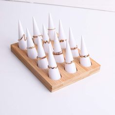 a wooden board topped with white cones on top of each other