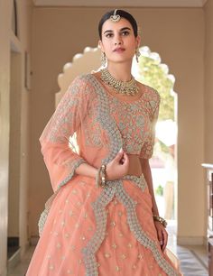 COLOR : Salmon Peach FABRIC : Top (Blouse) - Soft Net, Bottom (Lehenga) - Soft Net, Dupatta - Soft Net WORK : Metallic Thread Embroidery, Zari Work, Cutwork, Sequins, Motifs, Lace Border OCCASION : Wedding, Reception, Sangeet, Engagement READY-TO-WEAR : NoSTITCHING : Available as semi-stitched fabric, can be stitched using standard size option (+$30). Note: There might be a slight color variation due to lighting and flash used during photoshoot. The bright shade seen is the best closer view of f Salmon Peach, Peach Fabric, Embroidered Wedding, Zari Work, Wedding Lehenga, Net Dupatta, Thread Embroidery, Lace Border, Metallic Thread