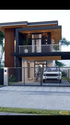 a car is parked in front of a modern house with balconyes and balconies