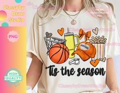 a woman wearing a t - shirt that says tis the season with basketball, hot dog and drink