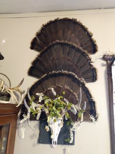 an animal skull and antlers are mounted on the wall