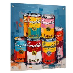 several cans of soup are stacked on top of each other in front of a blue background