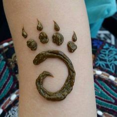 a person's arm with a tattoo on it that looks like a dog paw