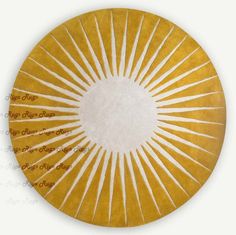 a yellow and white circular rug with sunbursts on the center in gold