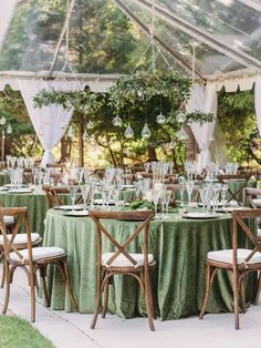 an outdoor tent set up with tables and chairs