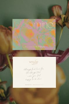 a close up of flowers with a business card