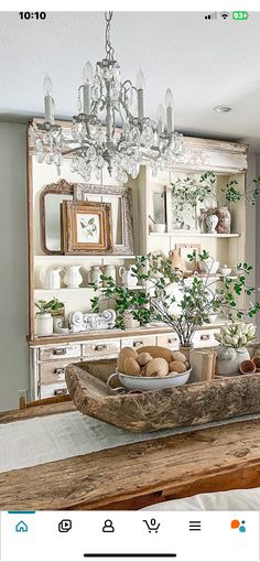 a dining room table with a bowl on it and some plants in the centerpiece